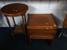 Teak nest of tables and a circular table