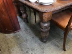 A Victorian carved oak dining table, with two leaves, 235cm length, 120cm wide