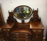 An Edwardian mahogany concave mirror back sideboard
