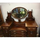 An Edwardian mahogany concave mirror back sideboard