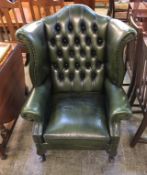 A green leather Chesterfield high back armchair