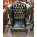 A green leather Chesterfield high back armchair