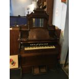 A mahogany mirror back American organ