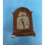 A reproduction walnut mantle clock