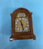 A reproduction walnut mantle clock