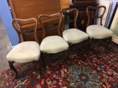 A set of four Victorian walnut chairs