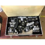 Collection of cameras including Comet, Balda etc., in a flight case