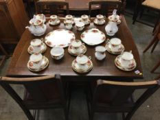 Oak drawer leaf table and four chairs