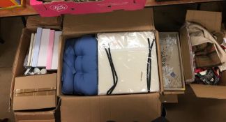 Four boxes of as new items, cushions, covers etc.