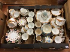 Two trays containing three-part tea services