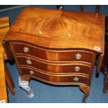 A reproduction mahogany drop flap chest of three drawers