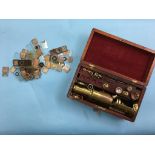 A brass field microscope and various lenses, in fitted mahogany case