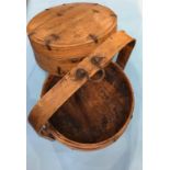 A Continental treen circular two tier food carrier