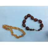 Two amber coloured bead necklaces