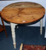 An antique pine circular cricket table