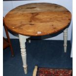 An antique pine circular cricket table
