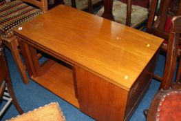 A teak nest of tables, with folding swivel top and side pocket