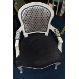 A cream painted carver chair, with grey upholstery