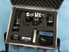 An Olympus camera, with various lenses and accessories, in flight case