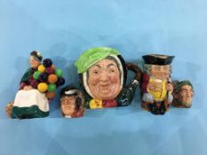 Royal Doulton 'The Balloon Seller', three character jugs and toby jugs
