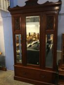 An Edwardian mahogany mirror door wardrobe