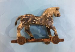 A distressed pull along wooden horse on wheels, 21cm wide