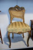 A gilt painted chair with bergère back. Contactless collection is strictly by appointment on