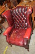 An oxblood Chesterfield wing back armchair. Contactless collection is strictly by appointment on