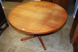 A teak extending circular dining table. Contactless collection is strictly by appointment on