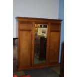 A mahogany triple door wardrobe with dental cornice and central mirror door, 183cm wide x 210 height