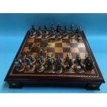 A metalwork chess set and chess board with Elizabethan design military figures. Contactless
