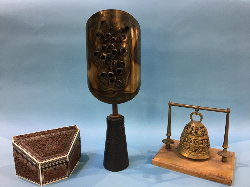 A metal modern sculpture, brass bell on wooden plinth and a wooden carved box for letters, with bone