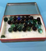 Tin of old marbles