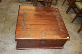 A square coffee table, with rising top