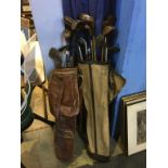 Two sets of various golf clubs and bags