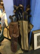 Two sets of various golf clubs and bags