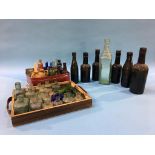 Seven glass advertising bottles to include; two trays of miscellaneous miniature bottles, B. and