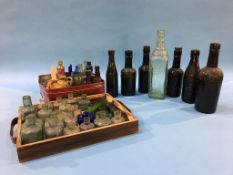 Seven glass advertising bottles to include; two trays of miscellaneous miniature bottles, B. and