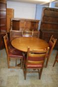 An oak court cupboard, circular Old Charm table and four Old Charm chairs