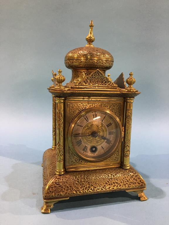 A small brass clock, the movement stamp Gustav Becker, with silvered chapter ring and single winding