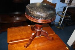 A leather top swivel circular stool