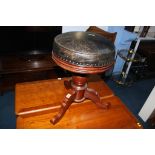 A leather top swivel circular stool