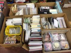 A large quantity of cards, shakers, domes, dies, floral toppers, embossing folders, Xyron Fabric