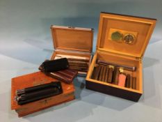 An oak cigar box, two humidors, two cigar cases and a hip flask and cigar case