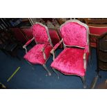 A pair of silver and pink upholstered French style armchairs