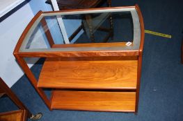 A teak three tier tea trolley, with glass top