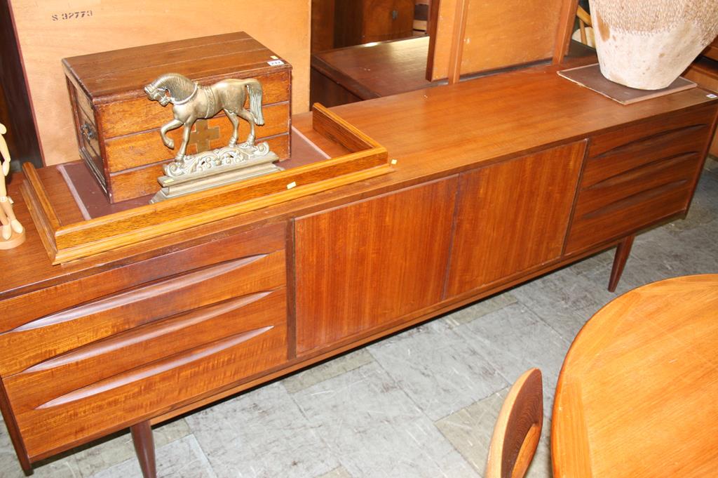 A British teak sideboard in the style of Arne Vodder for Sibast with two 'push' double doors flanked