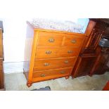 An Edwardian chest of drawers, with two short and three long graduated drawers, supported on