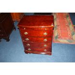A reproduction bow front chest of drawers, with brushing slide, 64cm wide