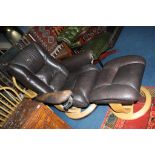 A brown leather swivel chair and footstool